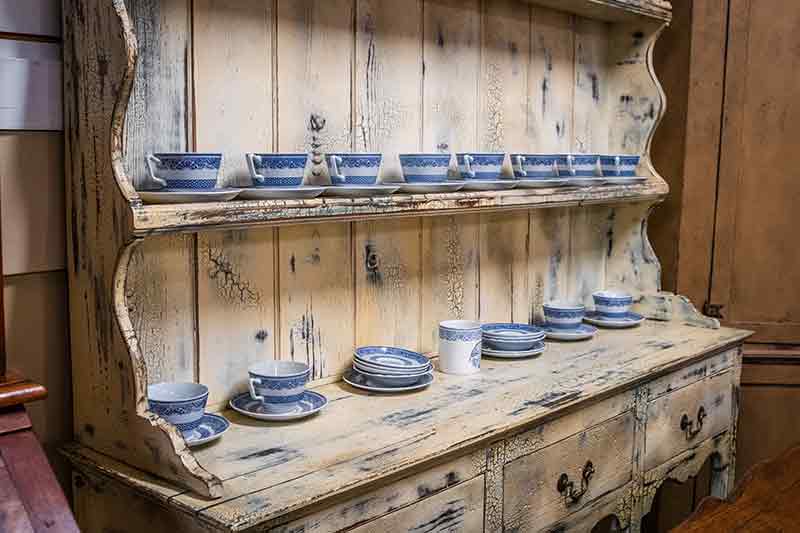 Wide antique cabinet and shelf with china dishes