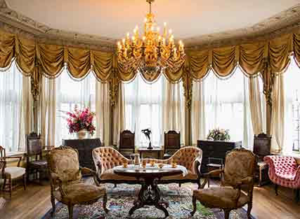 Round table with couch and chairs in an antique setting