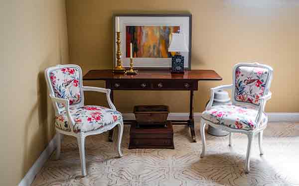 Decorated antique desk with two chairs